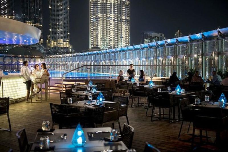Dine in style at Burj Club Rooftop with stunning views of Burj Khalifa and Dubai Fountain.